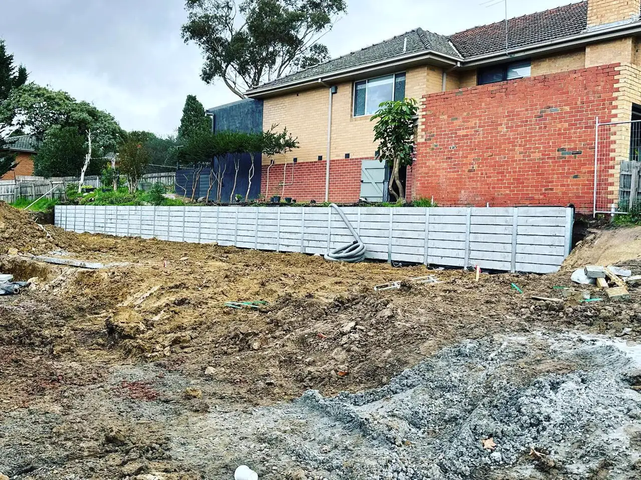 Retaining wall terracing a sloped site